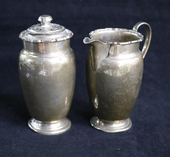 A late 1940s silver milk jug and a matching sugar shaker. 7 oz.
